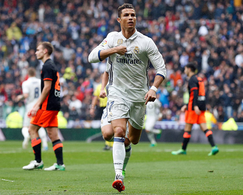 Cristiano Ronaldo points to himself as he runs away from Valencia box to celebrate near the fans