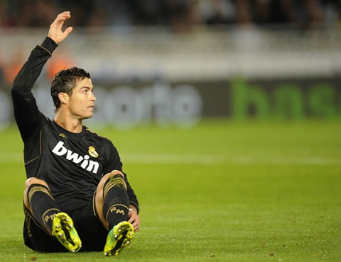 Cristiano Ronaldo sitted on the floor, waving at someone