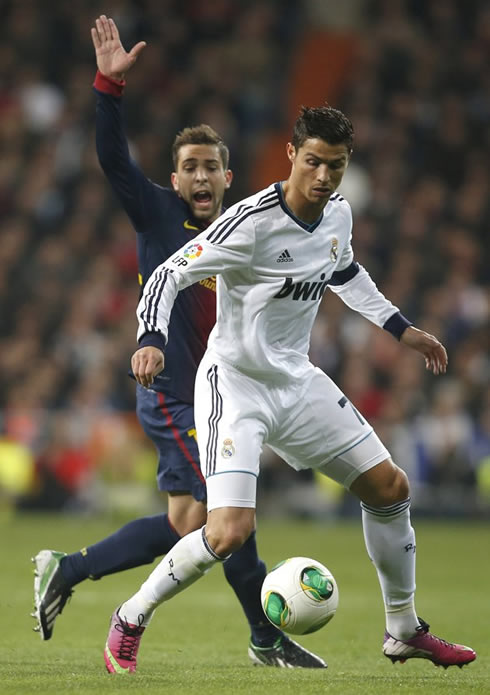 Cristiano Ronaldo shielding the ball from Jordi Alba, in Barcelona vs Real Madrid for the Copa del Rey 2013