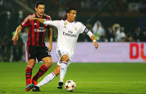 Cristiano Ronaldo running away from an AC Milan defender, at the Dubai Cup final