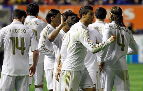 Cristiano Ronaldo celebrating a Real Madrid goal with his teammates in 2012