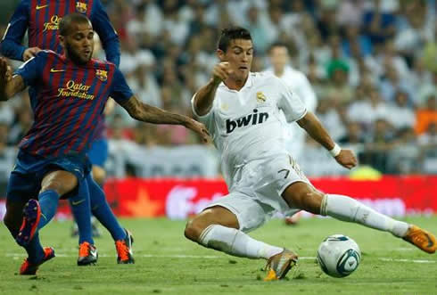 Cristiano Ronaldo falling and shooting, with Daniel Alves making opposition, in Real Madrid vs Barcelona 2011-2012