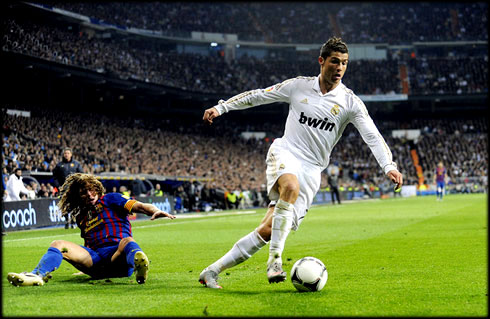 Cristiano Ronaldo dribbles Carles Puyol, but Real Madrid loses 1-2 against Barcelona, in the Copa del Rey 2011-2012
