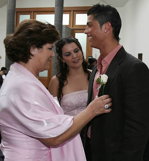 Cristiano Ronaldo in a pink shirt and black jacket, with his mother and sister at a special event
