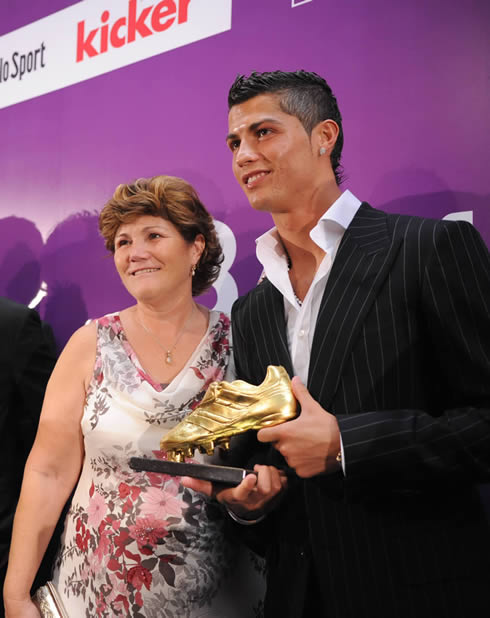 Cristiano Ronaldo holding the Golden Shoe/Boot, with his mother next to him