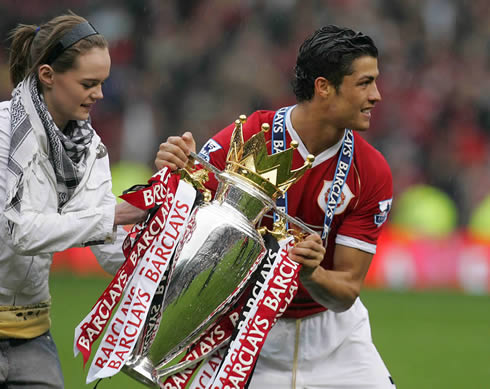 Cristiano Ronaldo holding the English Premier League trophy at Old Trafford, with a pretty chick near him