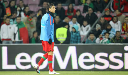 Cristiano Ronaldo during the warm-up for Portugal, with a Leo Messi banner/ad campaign on his the board behind him