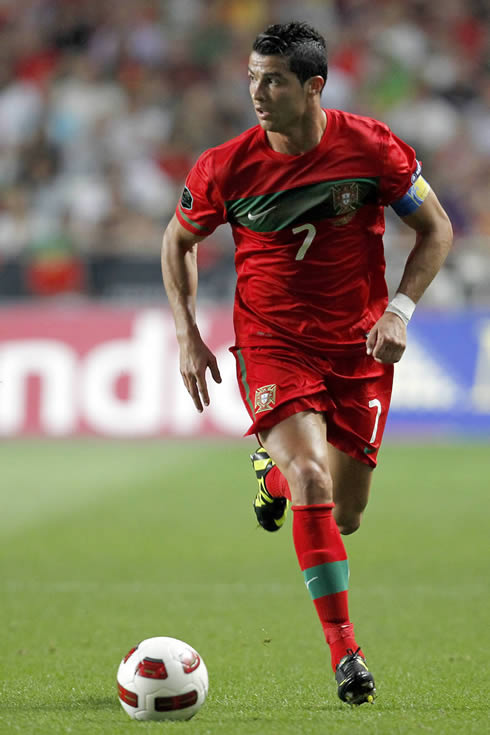 Cristiano Ronaldo wearing the Portuguese National Team captain armband and running with the ball