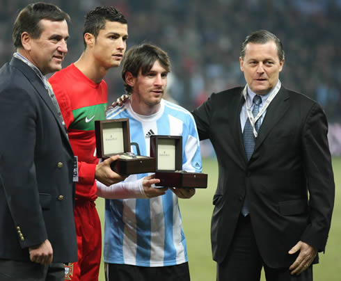 Cristiano Ronaldo and Lionel Messi holding their awards before a game between Portugal and Argentina