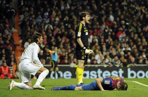 Iker Casillas yelling while Sergio Ramos and Iniesta stand near