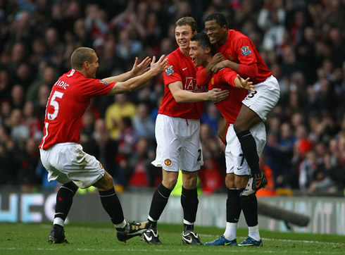 Cristiano Ronaldo with Patrice Evra on his back and Jonny Evans and Vidic joining the celebrations for a Manchester United goal