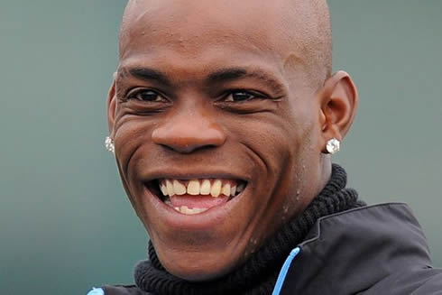 Mario Balotelli smiling and showing his white contrasting teeth