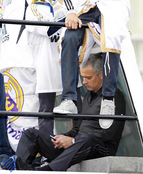 José Mourinho sending a text message SMS, from his mobile phone