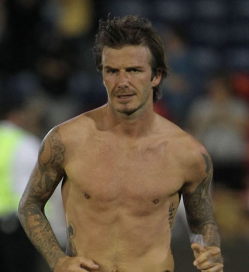 David Beckham shirtless and naked, showing his chest muscles and his arm tatoos