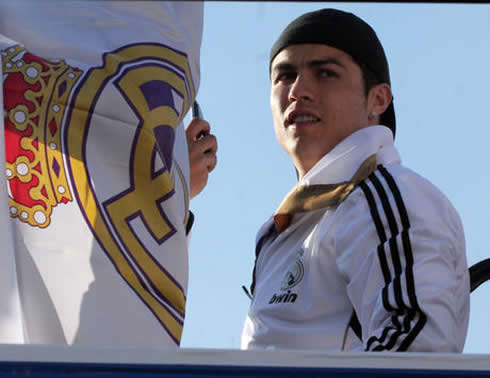 Cristiano Ronaldo next to a Real Madrid flag, in the Merengues bus in 2012