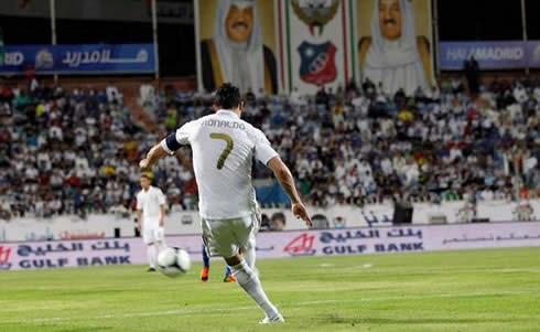 Cristiano Ronaldo taking a free-kick in Kuwait vs Real Madrid, with the team's captain armband on his left arm, in 2012