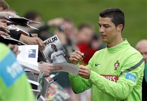 Cristiano Ronaldo signing autographs for the Portuguese crowd, in 2012