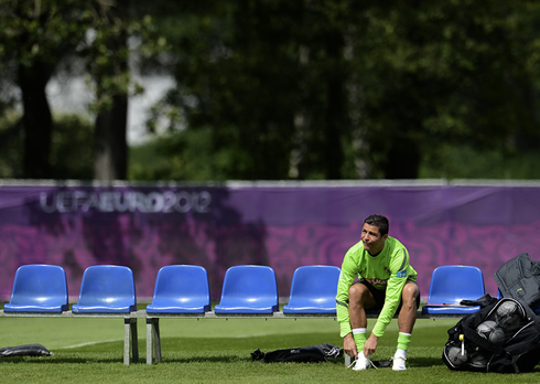 Cristiano Ronaldo putting his Nike and white boots/cleats, before a training practice session for the EURO 2012
