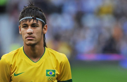 Neymar standing on the field, just before singing the Brazilian National Anthem, in Manchester, England, in 2012