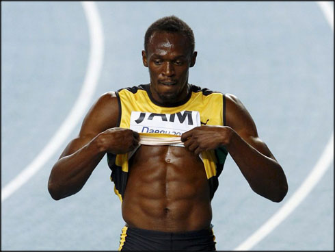 Usain Bolt six pack abs and ripped body low fat level, almost shirtless by showing his body muscles, in 2012