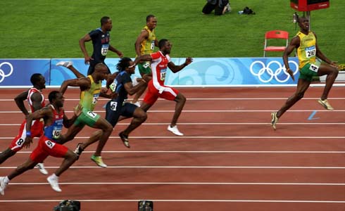 Usain Bolt setting a world record, at the 100m, and acting cocky as he gets close to the finish line, in the Beijing 2008 Olympics