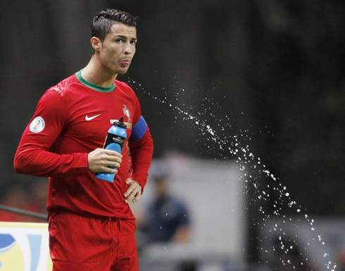 Cristiano Ronaldo drinking Powerade and spitting it immediatly after, during a soccer game for Portugal, in 2012