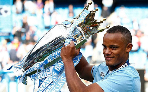 Manchester City captain, Vincent Kompany, holding the English Premier League trophy, at the end of the 2011-2012 season