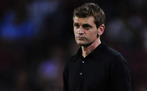 Tito Vilanova wearing a black shirt and suit, in a Barcelona match in 2012-2013