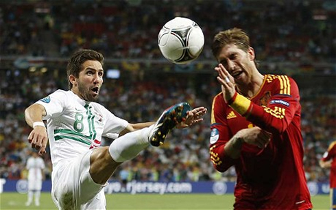 João Moutinho challenging the ball against Sergio Ramos, in Portugal vs Spain at the EURO 2012