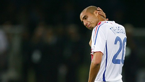 David Trézéguet scratching his bald head in a game for the French National Team