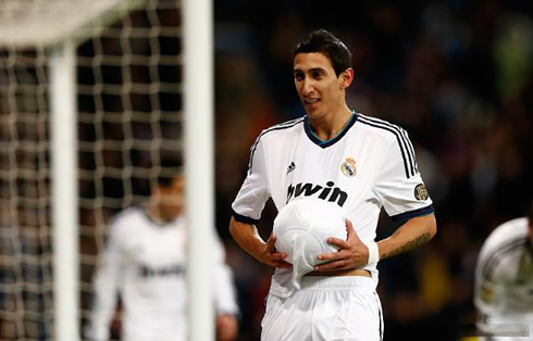 Angel Di María celebrating a goal, using the ball as if it was a baby beneath his Real Madrid shirt, in a soccer game in 2012-2013