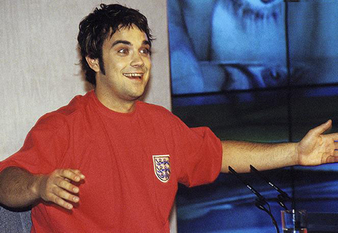 Robbie Williams fat and looking like a crazy junkie on drugs, with an England jersey just after he left Take That