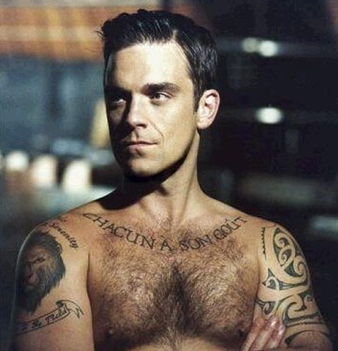 Robbie Williams showing off his tattoos