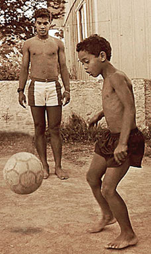 Ronaldinho at a very young age, playing football in the street when he was a kid and someone's young child