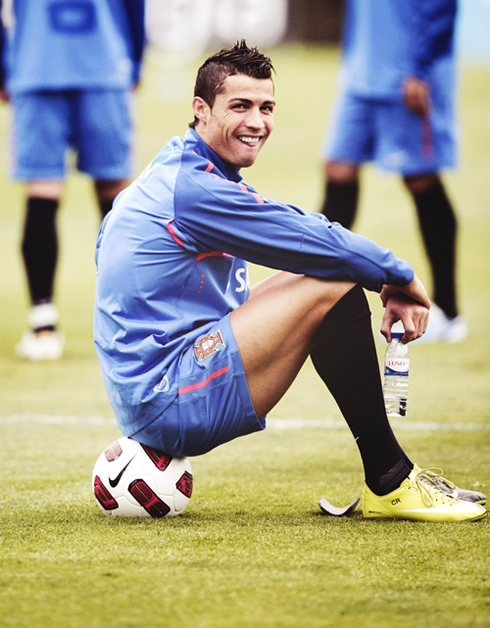 Cristiano Ronaldo in good mood, at the Portuguese National Team, sitting on a football