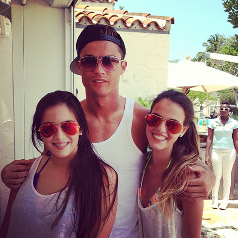 Cristiano Ronaldo taking a picture with two hot fans, in Miami in 2013