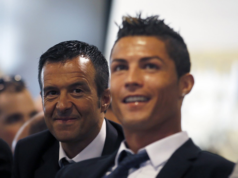 Jorge Mendes smiling behind Cristiano Ronaldo