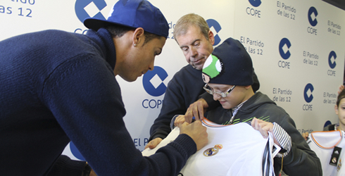 Cristiano Ronaldo signing his jersey for a young kid and fan