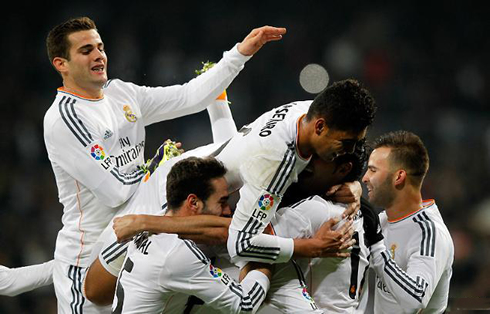 Real Madrid players piling up in celebrations, after scoring a goal