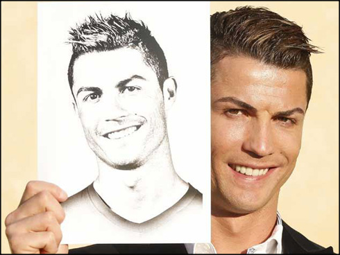 Cristiano Ronaldo holding his own drawing in 2014
