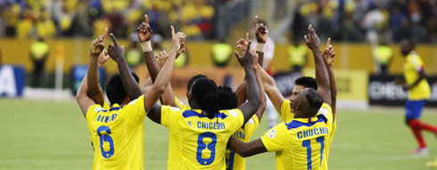 Ecuador players praying during a football game