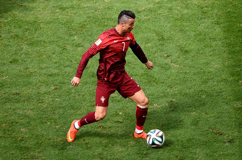 Cristiano Ronaldo wearing Portugal's red kit, in the FIFA World Cup 2014