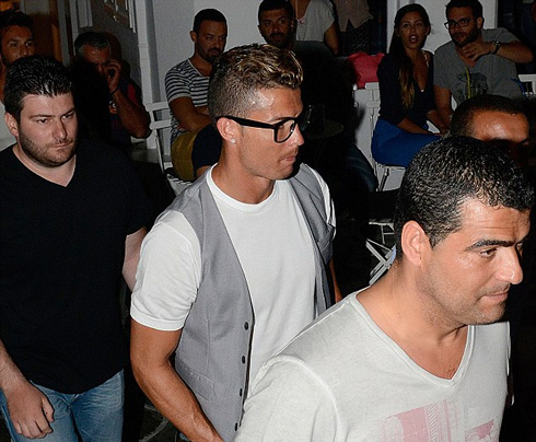 Cristiano Ronaldo walking right behind his brother Hugo, in Greece