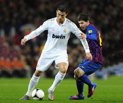 Cristiano Ronaldo guarding the ball from Messi