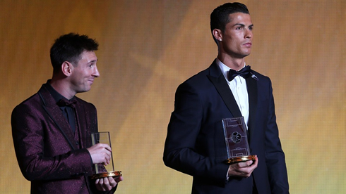 Messi and Cristiano Ronaldo holding their FIFA best XI player awards