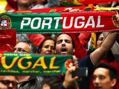 Portuguese fans raising their Portugal scarves in the stadium