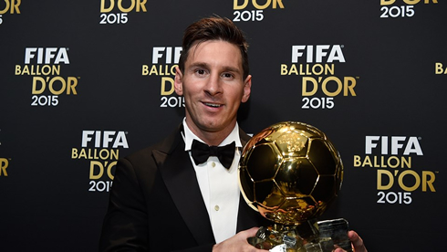 Lionel Messi holding the 2015 FIFA Ballon d'Or trophy