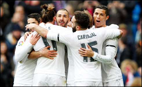 Real Madrid players hugging each other after a goal