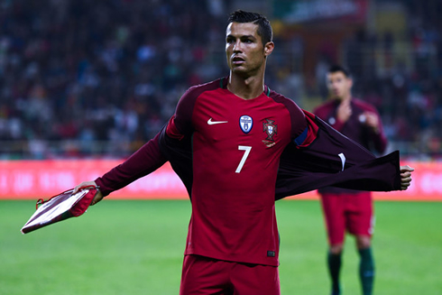 Cristiano Ronaldo takes off his jacket before a game for Portugal