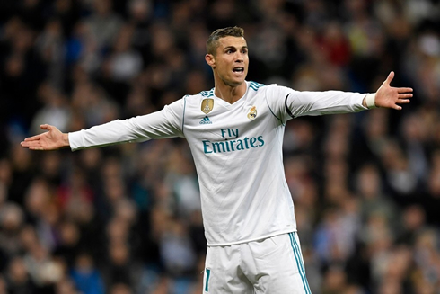 Cristiano Ronaldo opens his arms to protest a decision